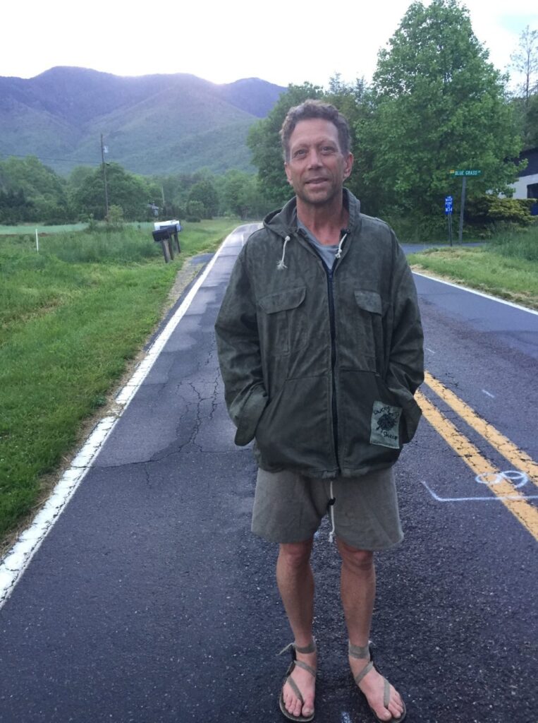 Beeswax-finished cotton shell jacket worn on a mountain road