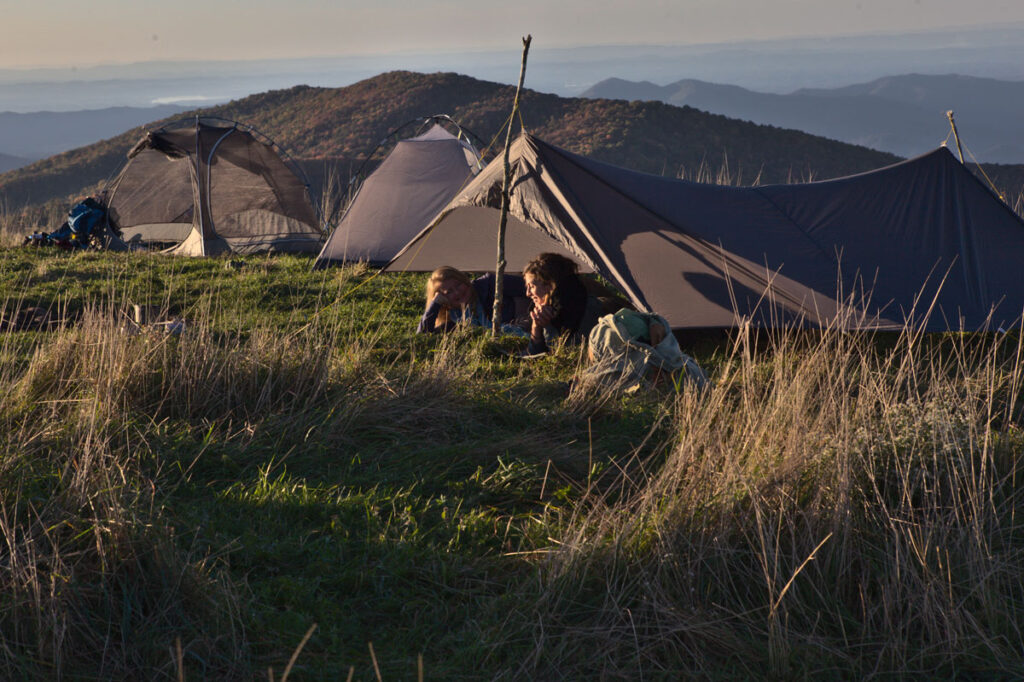 two-girls-in-open-tarp-talking-scenery